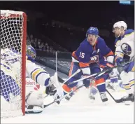  ?? Bruce Bennett / Getty Images ?? The Islanders’ Cal Clutterbuc­k (15) scores a third-period goal against the Sabres’ Jonas Johansson (34) on Sunday.
