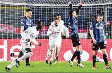  ?? AFP ?? Real Madrid’s French defender Ferland Mendy (front left) celebrates after opening the scoring during the UEFA Champions League round of 16 first leg football match on Wednesday.