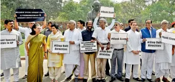  ?? PTI ?? Former Congress president Sonia Gandhi stands along with Opposition party members during a protest outside Parliament during the Budget Session in New Delhi on Thursday. AICC president Rahul Gandhi and other leaders are also seen. —