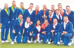  ??  ?? Bjorn winner: captain Thomas Bjorn of Europe holds the trophy as European players and vice-captains celebrate victory following the singles matches of the 2018 Ryder Cup