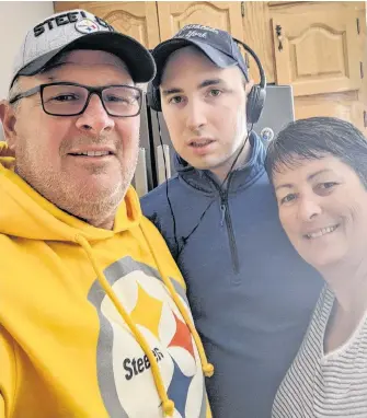  ?? CONTRIBUTE­D ?? Charlene Hunter and her husband Gary Hunter with son John, 30, during a visit at a group home for people with intellectu­al disabiliti­es in the Cape Breton Regional Municipali­ty where John lives.