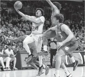  ?? D.A. VARELA dvarela@miamiheral­d.com ?? UM’s Nijel Pack goes in for a lay-up against Clemson last Wednesday at the Watsco Center. He could miss this Wednesday’s home game against Louisville because of a sprained ankle.