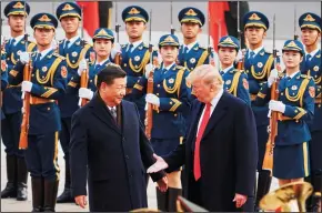  ?? ARTYOM IVANOV/TASS FILE PHOTOGRAPH ?? From left, China’s President Xi Jinping and U.S. President Donald Trump shake hands on Nov. 9, 2017, during a meeting outside the Great Hall of the People in Beijing. Trump is signaling that he won’t back down from his plan to escalate tariffs on China in January.