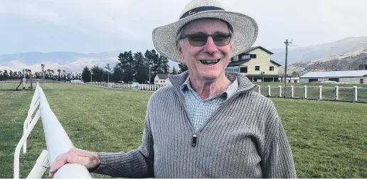  ?? PHOTO: MARJORIE COOK ?? Better protection . . . Central Lakes Equestrian Club volunteer Gordon Stewart with new plastic rails installed at the Cromwell racecourse this year.