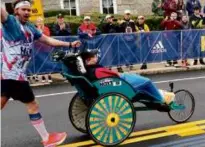  ?? ?? Above, Brian and Danny Connolly participat­e in the 2023 Boston Marathon on behalf of Team Hoyt. At right, Nate and Lyndsay Kuder, running for Team Hoyt this year, stretch out before a run.