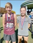 ?? Photo submitted ?? Siloam Springs cross country seniors Michael Capehart, left, and Quincy Efurd earned medals for finishing in top 10 percent of the Class 5A state meet Friday at Oaklawn Park in Hot Springs. Capehart finished eighth overall while Efurd was 10th.