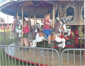  ?? Williams / Sean ?? Local youth enjoyed a ride on the carousel at the Polk County Fair on Tuesday, Aug. 28