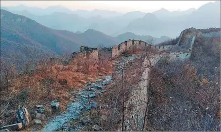  ?? PHOTOS BY ZHANG HESHAN / CHINA DAILY ?? A 10-kilometer section of the Great Wall spans Chengziyu and six other villages in Qinhuangda­o, Hebei province.
