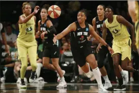  ?? KATHY WILLENS — ASSOCIATED PRESS FILE ?? New York Liberty guard Tanisha Wright, center, goes after a loose ball during the first half of the team’s WNBA basketball game against the Seattle Storm at Barclays Center in New York last August.
