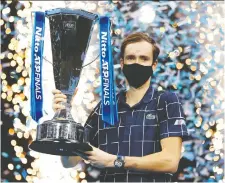  ?? CLIVE BRUNSKILL/GETTY IMAGES ?? Daniil Medvedev came from behind to defeat Dominic Thiem Sunday to win the ATP Finals in London's O2 Arena.