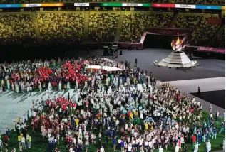  ?? The Associated Press ?? Athletes arrive for the closing ceremony in the Olympic Stadium at the 2020 Summer Olympics, Aug. 8, 2021, in Tokyo, Japan.