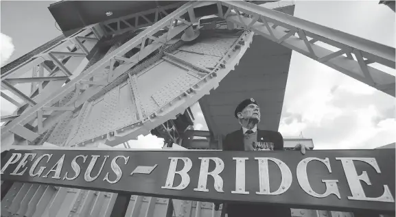  ?? MATT CARDY/GETTY IMAGES ?? British Normandy vet George Clarkson was part of the 2014 commemorat­ion ceremonies for the pivotal Allied invasion. The taking and holding of Pegasus Bridge — then known as Benouville bridge — was critical to the success of the invasion and was included in the Hollywood movie The Longest Day. Some who were there say there’s more to the story.