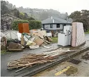  ?? BRADEN FASTIER/STUFF ?? Debris piles up along Nile St, Nelson, as the cleanup continues after recent flood events affected the city.