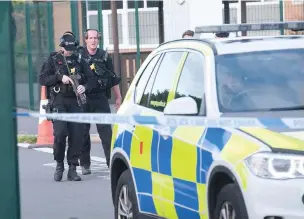  ??  ?? ●●Armed police at the scene just after the incident in September