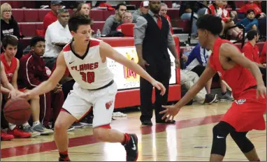  ?? PHOTOS BY MIKE BUSH/NEWS-SENTINEL ?? Above: Lodi guard Colton Stout looks for an opening in the defense against a McClatchy player in Monday's Foundation Game at The Inferno. Lodi guard Zoe Faulkner (left) and teammate Annette Vasquez corral McClatchy's Samaya Beatty on the rebound.