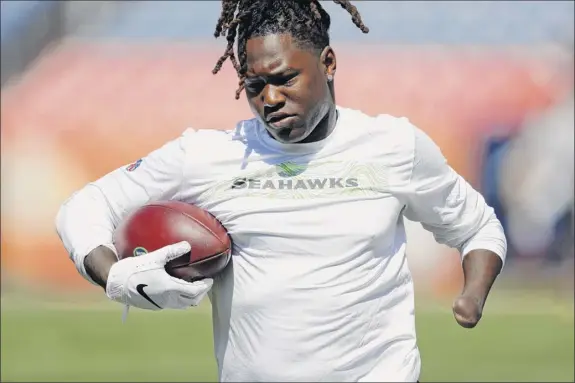  ?? David Zalubowski / Associated Press ?? Seattle Seahawks linebacker Shaquem Griffin warms up before an NFL football game against the Denver Broncos.