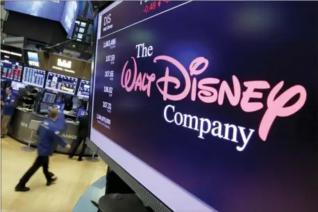  ?? RICHARD DREW — THE ASSOCIATED PRESS FILE ?? In this file photo, The Walt Disney Co. logo appears on a screen above the floor of the New York Stock Exchange. On Tuesday, Nov. 12, Disney Plus launches its streaming service.