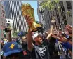  ?? JOSE CARLOS FAJARDO — BANG, FILE ?? The Warriors' Stephen Curry holds the NBA Finals MVP trophy as he greets fans during the Championsh­ip Parade on Market Street in San Francisco in June.