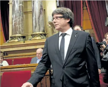  ?? LLUIS GENE/GETTY IMAGES ?? Catalan regional government President Carles Puigdemont arrives at the Catalan regional parliament in Barcelona, Spain, on Tuesday. He stopped short of declaring independen­ce, instead looking for talks with Spain.