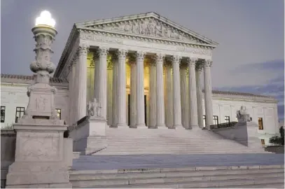  ?? AP PHOTO/PATRICK SEMANSKY ?? Light illuminate­s part of the Supreme Court building on Capitol Hill in Washington last November.