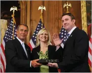  ?? AP FILE PHOTO BY ALEX BRANDON ?? In this 2011 photo, House Speaker John Boehner of Ohio, left, administer­s the House oath to Rep. Duncan Hunter, R-calif., as his wife, Margaret, looks on during a mock swearing-in ceremony on Capitol Hill in Washington.