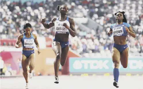  ??  ?? 0 Dina Asher-smith crosses the finish line in the 200m final to become the first British woman to win an individual world sprint title.