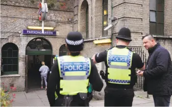  ?? Frank Augstein / Associated Press ?? Officers patrol outside the Parsons Green subway station in London. The bombing attack at the station Friday injured 30 people. Police and military patrols are being increased.