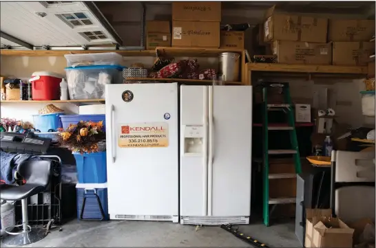 ?? (The New York Times/Swikar Patel) ?? A refrigerat­or and freezer have a home in the garage of Robyn Penniegraf­t. For many Americans, a second fridge — and sometimes a third — is like another member of the family.