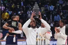  ?? DARRON CUMMINGS — THE ASSOCIATED PRESS ?? Milwaukee Bucks guard Damian Lillard lifts the MVP trophy after the East defeated the West 211-186Sunday in the NBA All-Star Game in Indianapol­is. Lillard scored 39points.