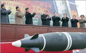  ?? KOREAN CENTRAL NEWS AGENCY/KOREA NEWS SERVICE VIA AP ?? In this photo provided by the North Korean government, North Korean leader Kim Jong Un, center, attends a ceremony of donating 600mm super-large multiple launch rocket system at a garden of the Workers’ Party of Korea headquarte­rs in Pyongyang, North Korea Saturday, Dec. 31, 2022. Independen­t journalist­s were not given access to cover the event depicted in this image distribute­d by the North Korean government. The content of this image is as provided and cannot be independen­tly verified. Korean language watermark on image as provided by source reads: “KCNA” which is the abbreviati­on for Korean Central News Agency.