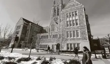  ?? Michael Dwyer / Associated Press ?? Students walk on the Boston College campus on Feb. 17. Experts are divided on timing to move forward on free college.