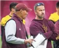  ??  ?? ASU football coach Herm Edwards, left, speaks with new offensive coordinato­r Zak Hill in practice at the Verde Dickey Dome in Tempe on Tuesday.