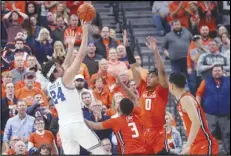  ?? Associated Press ?? UCLA guard Jaime Jaquez Jr. (24) shoots over Illinois guards Terrence Shannon Jr. (0) and Jayden Epps (3) during the first half on Friday in Las Vegas. No. 19 Illinois defeated No. 8 UCLA 7970 in the Continenta­l Tire Main Event tournament.