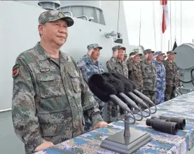  ?? LI GANG/XINHUA VIA AP ?? Chinese President Xi Jinping oversees the country’s largest military drill in modern history in April 2018. The drill took place in the South China Sea and included 76 fighter jets and 48 warships.