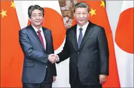 ?? Li Tao New China News Agency ?? THE BEIJING meeting between Japanese Prime Minister Shinzo Abe, left, and Chinese President Xi Jinping was the nations’ first summit in seven years.