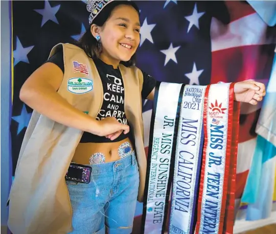  ?? NELVIN C. CEPEDA U-T PHOTOS ?? At her home in Lakeside, Bianca Villalobos displays three titles won in pageant competitio­ns. Her primary goal is to raise awareness of her two chronic illnesses.