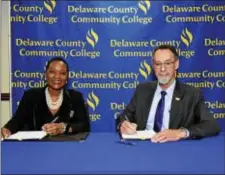  ??  ?? Delaware County Community College President L. Joy Gates Black and West Chester University President Christophe­r M. Fiorentino sign the new West Chester University Bachelor of Science in Business Management degree-completion program agreement.