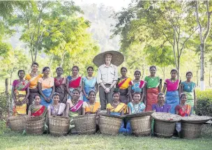  ??  ?? Paul O’Grady with the tea-pickers of the Kaziranga tea gardens in India