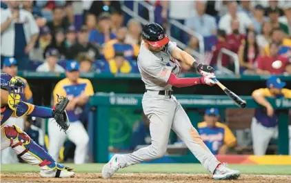  ?? WORLD BASEBALL CLASSIC WILFREDO LEE/AP ?? The United States’ Trea Turner hits a go-ahead grand slam during the eighth inning of Saturday’s World Baseball Classic game against Venezuela in Miami. Tim Anderson, J.T. Realmuto and Bobby Witt Jr. scored on the play.