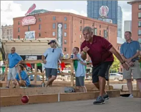  ?? Haldan Kirsch/Post-Gazette ?? A DAY AT THE COURT Team La Bocce Vita’s Vince Tucceri, of Moon, throws a ball Saturday during the Heinz History Center’s 10th annual Bocce Tournament and Festival in the Strip District. The fundraiser, which supports the center’s Italian American Program, also featured Italian food and live music. The program, founded in 1990, is dedicated to preserving the history and culture of Italian Americans in Western Pennsylvan­ia.