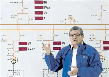  ?? Cristina Vega AFP/Getty Images ?? ECUADOREAN utility manager Gonzalo Uquillas tours the $2.8-billion Coca Codo Sinclair dam, which was built with Chinese loans. The dam is operating at half capacity after serious structural problems came to light.