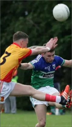  ??  ?? Fran Cleary (Sarsfields) is a fraction too late in his bid to block the kick of Rioghan Crosbie (Glynn-Barntown).