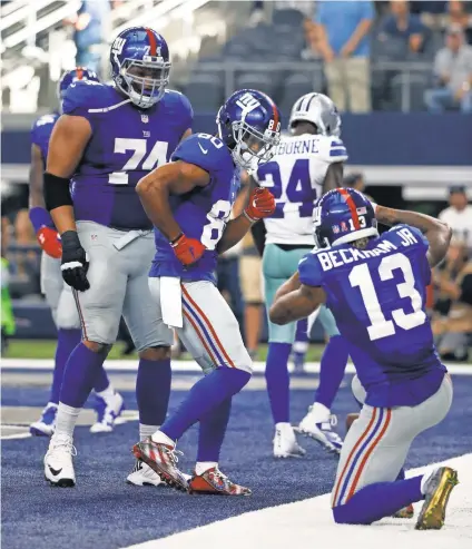  ?? MICHAEL AINSWORTH, AP ?? The Giants’ Victor Cruz (80) and Odell Beckham Jr. (13) were fined for this end-zone celebratio­n.