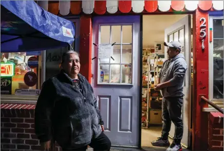  ?? PHOTOS BY RAY CHAVEZ — STAFF PHOTOGRAPH­ER ?? Hilltop Grocery owner Maria Melgar, left, and her employee Marco Antonio Perez call it a day on a recent Wednesday in February in Half Moon Bay. Melgar and her market have become a fixture for Half Moon Bay's immigrant community, who mostly come from Mexico and Guatemala.