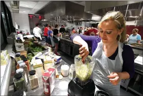  ?? NWA Democrat-Gazette/J.T. WAMPLER ?? Anastasia Strokova of Elm Springs makes a salad dressing Wednesday at Northwest Arkansas Community College’s Brightwate­r.