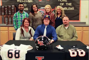  ??  ?? Family, friends and coaches were at LaFayette High School on Wednesday to watch senior Jake Russell sign a letter of intent to play football at Reinhardt University next season. Among those in attendance at the signing ceremony were Tabitha and Brian...