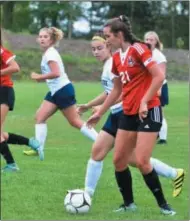  ?? JOHN BREWER - ONEIDA DAILY DISPATCH ?? Vernon-Verona-Sherrill senior midfielder Alexa Kiser surveys the Utica Notre Dame defense while sister Laiken Kiser, an eighth grade striker, makes a run during an 11-0 Red Devil win over the Jugglers on Tuesday, Sept. 11.