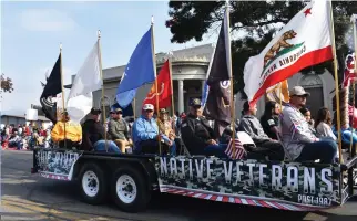  ?? PHOTO FOR THE RECORDER BY JAMIE A. HUNT ?? Those from Tule River Native Veterans Post 1987 ride on their float during Thursday’s Veterans Day Parade.