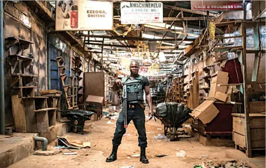  ??  ?? A security guard at the empty Ogbaru Market as shops and businesses shut down to mark the anniversar­y of the declaratio­n of Biafra independen­ce last year