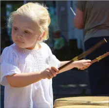  ??  ?? ABOVE: Neasa O’Sullivan in rhythm with the music as she tries out the drums during the July 4 fun in Killarney last week.